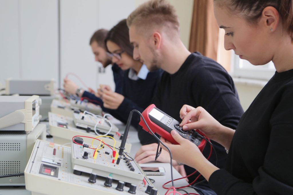 Students learning to use a multimeter in a nonprofit training center