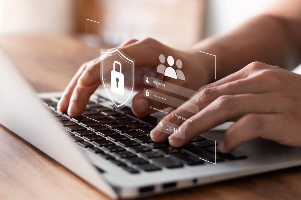 Person filling in a password on a laptop