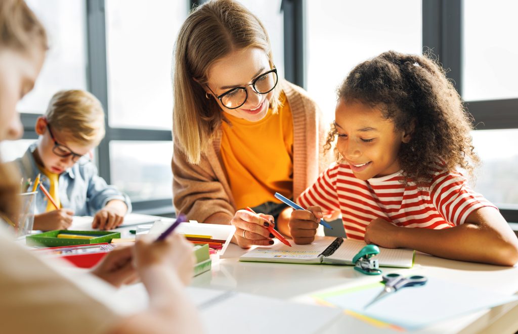 Teacher helping child with studies