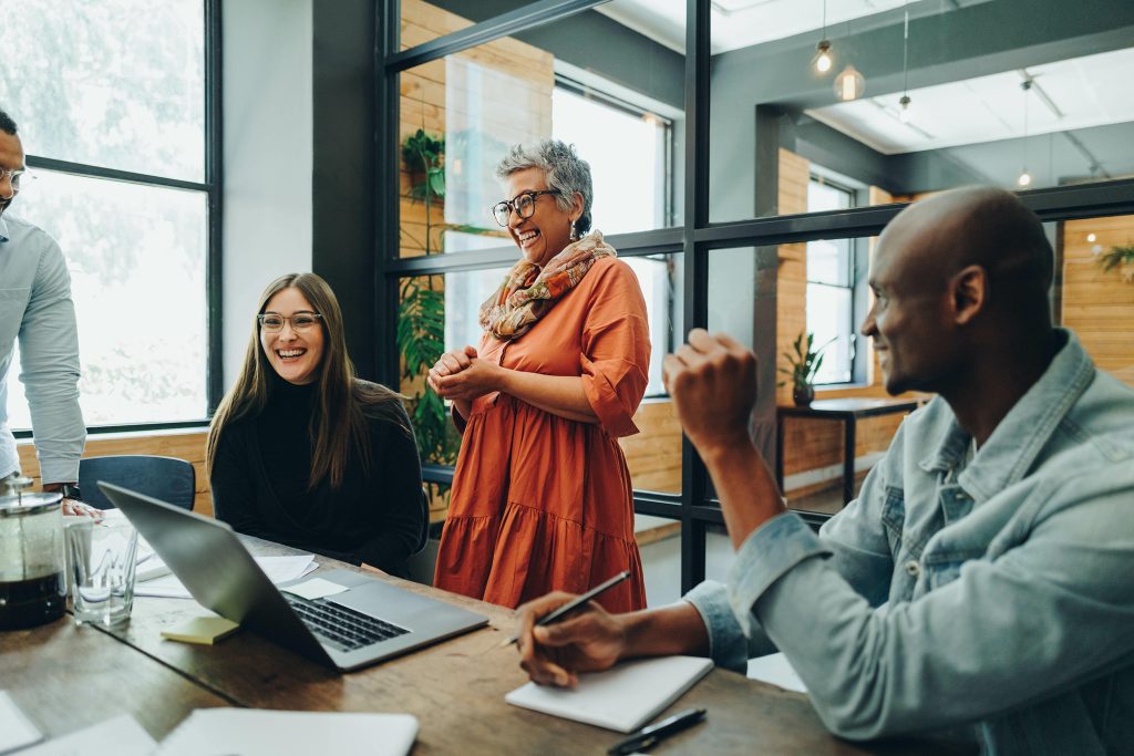 People at a nonprofit organization office having a meeting and laughing