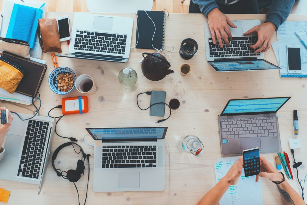 Small business employees working on their laptops and phones at an office desk