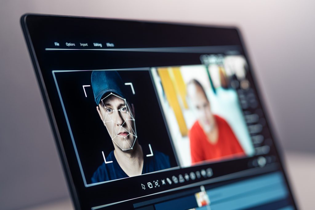 laptop screen with an open program creating a deepfake of a man on the left, while the picture of another man on the right is blurred