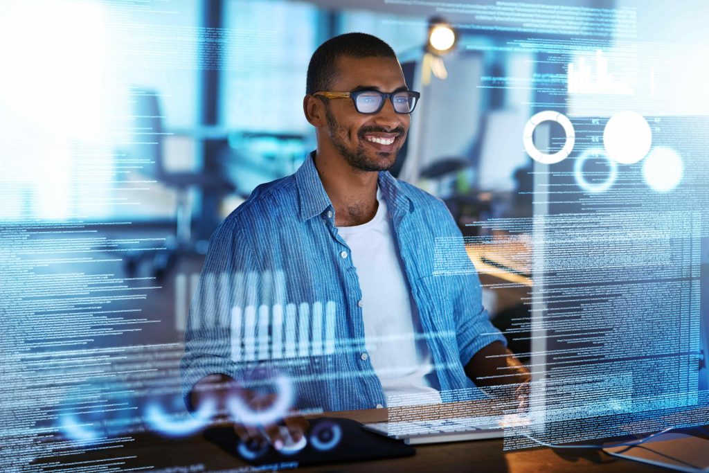 Professional looking man working on a computer with code snippets surrounding him