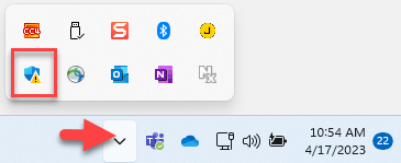 The screenshot features the Windows taskbar, highlighting the Windows Defender icon marked with a triangular yellow warning symbol.