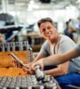 Men working in manufacturing smiling and conversing